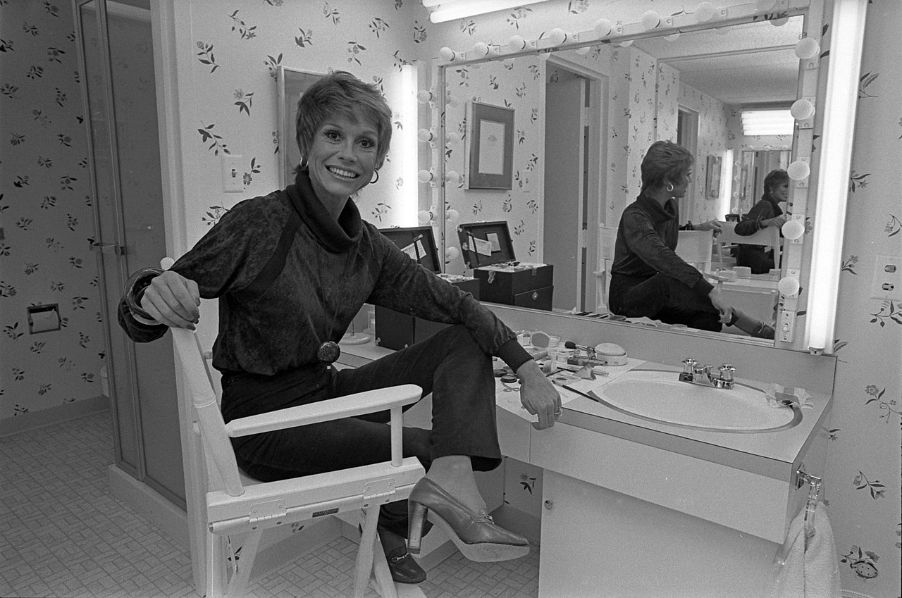 Mary Tyler Moore sitting in front of a dressing table