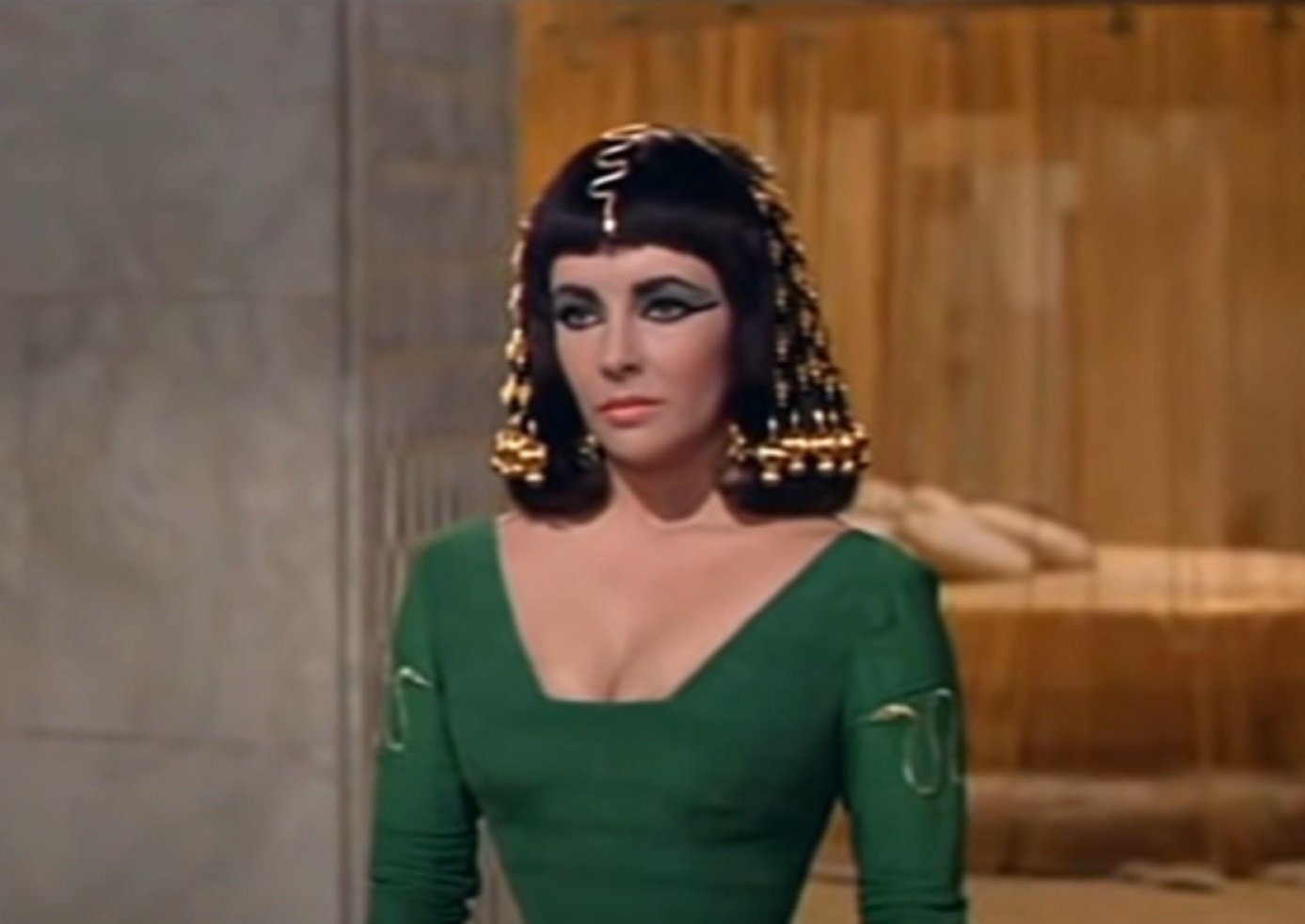 Screenshot: (Elizabeth Taylor) Cleopatra wearing green dress is looking at side - from Cleopatra (1963)