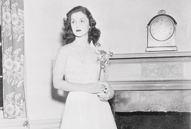 Charming Brenda Diana Duff Frazier at the Bachelors Cotillion in Baltimore, is pictured in her coming-out dress of white brocade with corsage