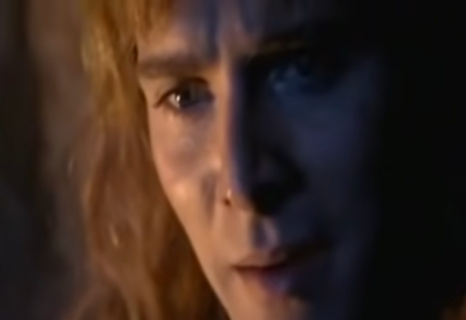 Screenshot: (Mark Umbers) Perkin Warbeck with long hair is looking at side - from Princes in the Tower (2005).