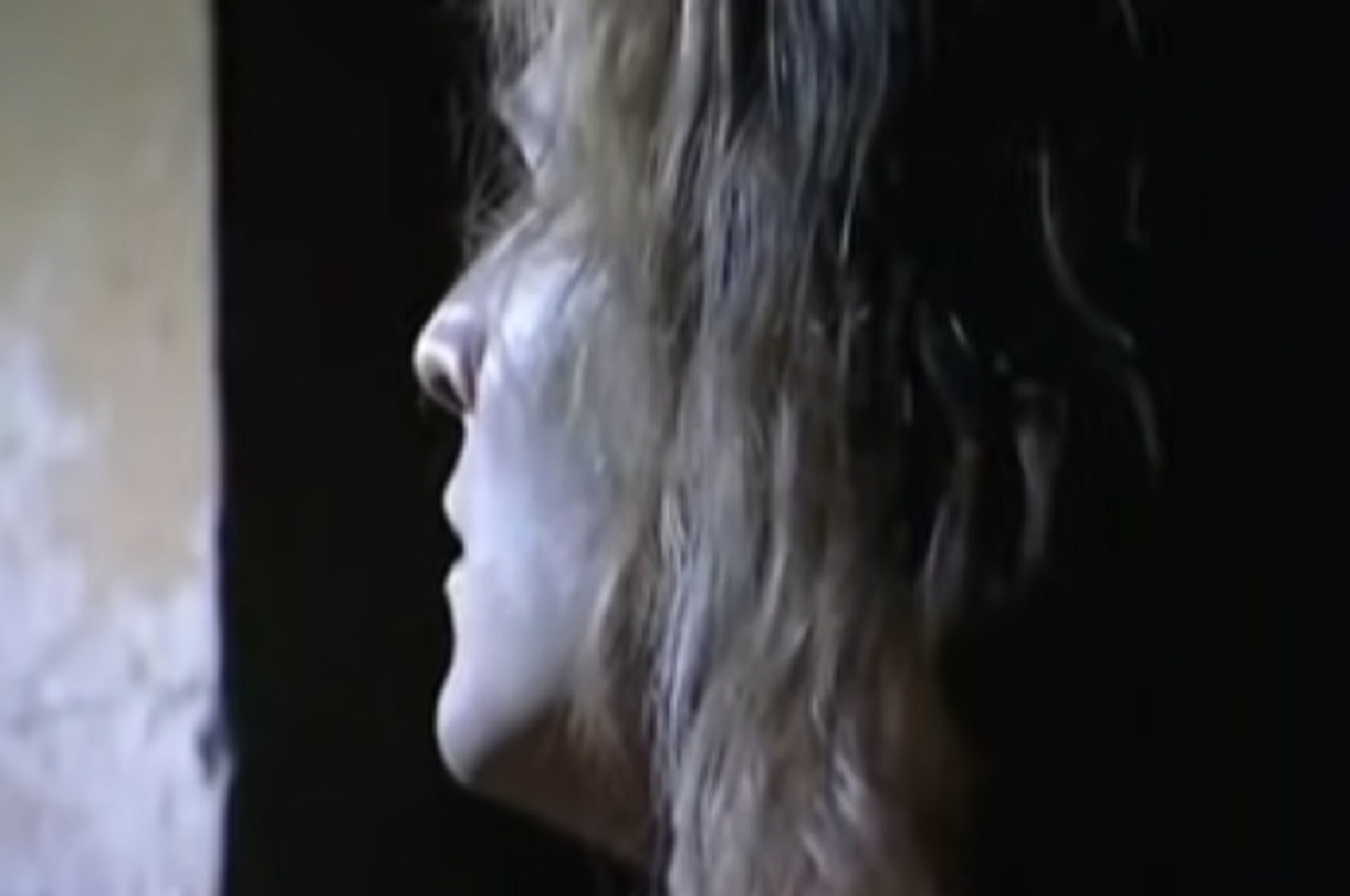 Screenshot: (Mark Umbers) Perkin Warbeck with long hair is looking from the window - from Princes in the Tower (2005).