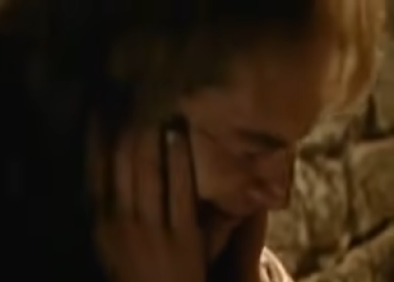 Screenshot: (Mark Umbers) Perkin Warbeck with long hair is looking down and crying - from Princes in the Tower (2005).