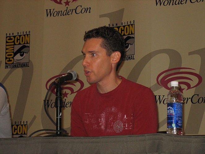 Bryan Singer at WonderCon 2006 wearing a ret shirt speaking to the microphone