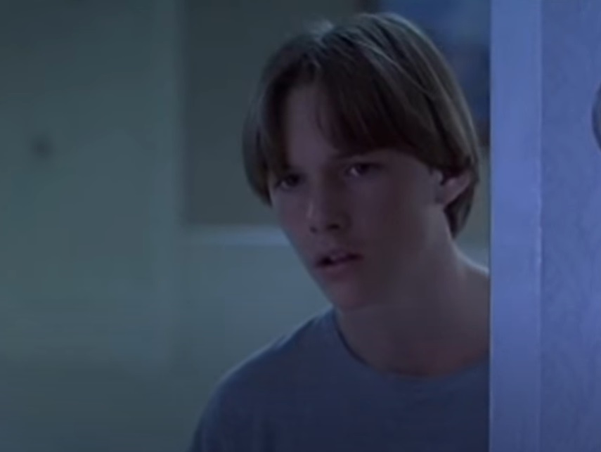 Screenshot of the actor Brad Renfro from the Movie The Cure (1995) depicting a teenager wearing blue t-shirt facing the camera
