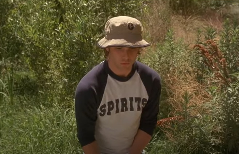 Screenshot of the actor Brad Renfro from the Movie American Girl (2002) depicting a young man, looking downwards,