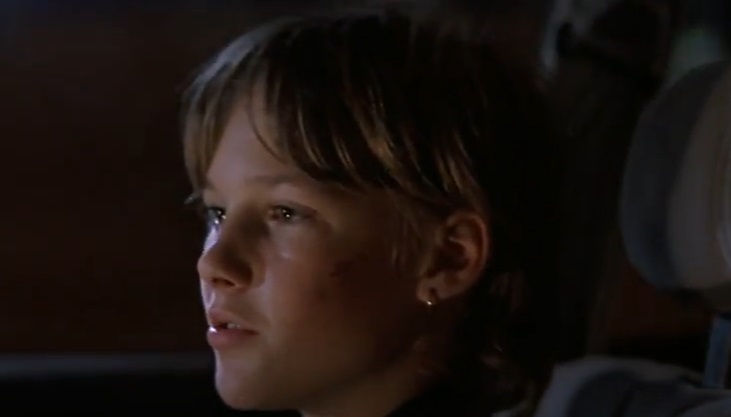 Screenshot of the actor Brad Renfro from the Movie The Client (1994) depicting aboy looking to the left