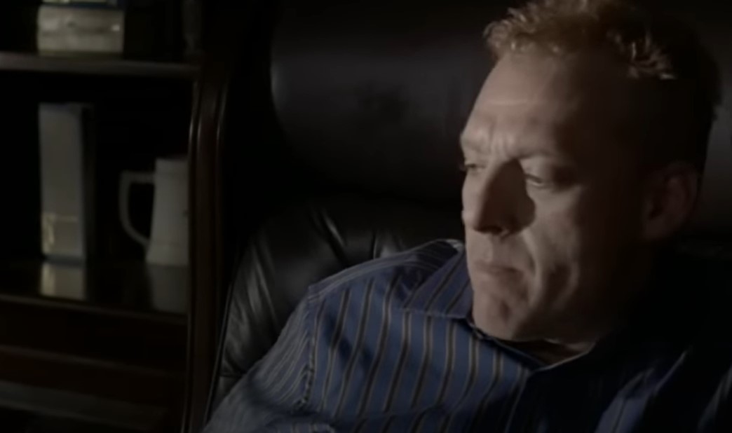 Tom Sizemore in Red siting on an armchair