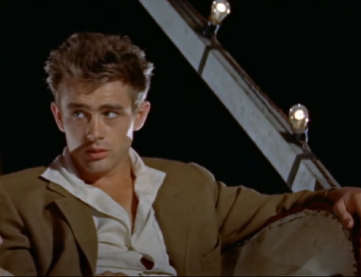 Screenshot: photo of James Dean wearing suit and looking at side - from the East Of Eden (1955).