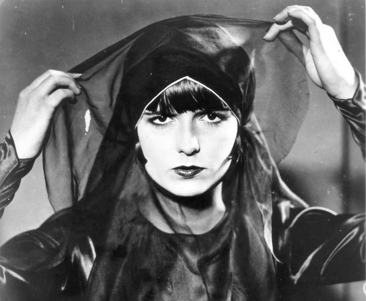American actress Louise Brooks in a publicity photo for for the Movie Pandora's Box (1929). wearing a black dress and black hat