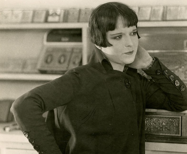 Grayscale Portrait Photo of the actress Louise Brooks, wearing dark dress