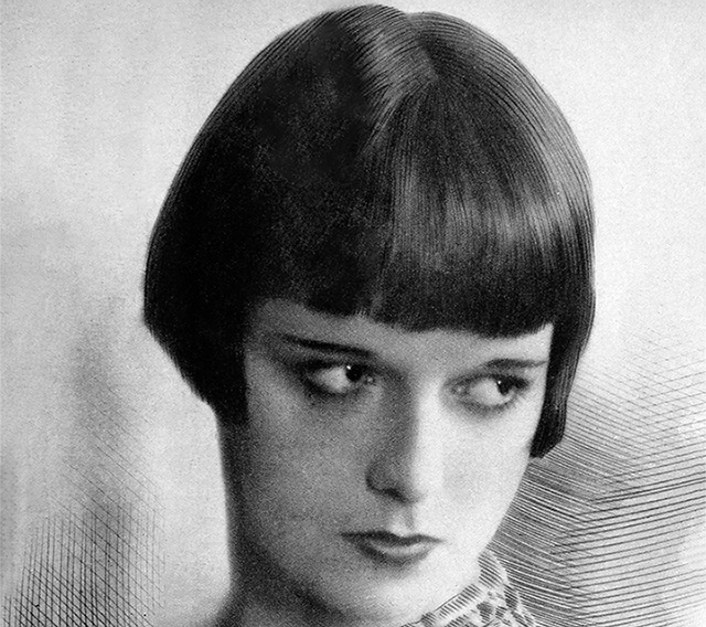 Grayscale Portrait Photo of the actress Louise Brooks, wearing a closed neck dress