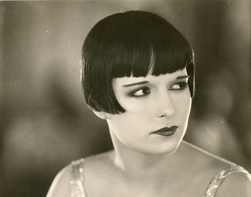 Grayscale Portrait Photo of the actress Louise Brooks, wearing light dress, looking to the right