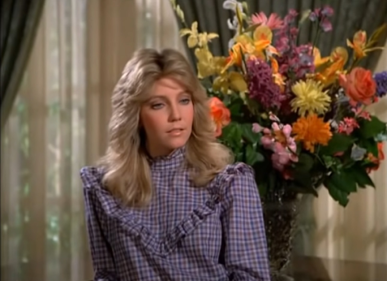 Screenshot of Heather Locklear wearing purple dress and looking at side - from Dynasty (1981)
