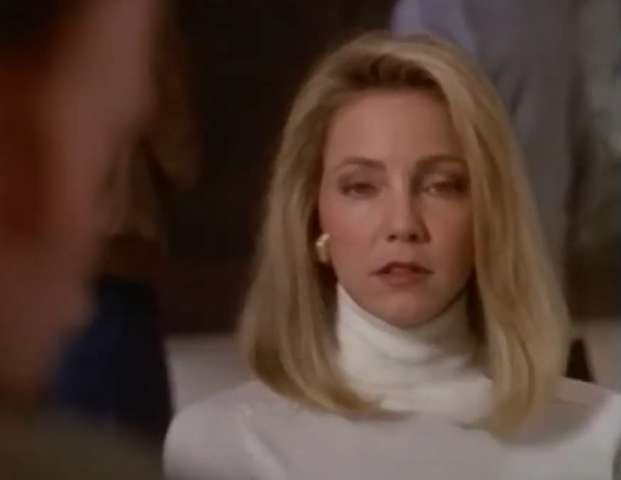 Screenshot of Heather Locklear wearing white sweater is looking sad - from Fade to Black (1993)