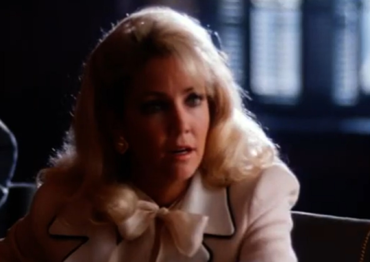 Screenshot of Heather Locklear wearing white jacket is looking at side - from Texas Justice (1995)
