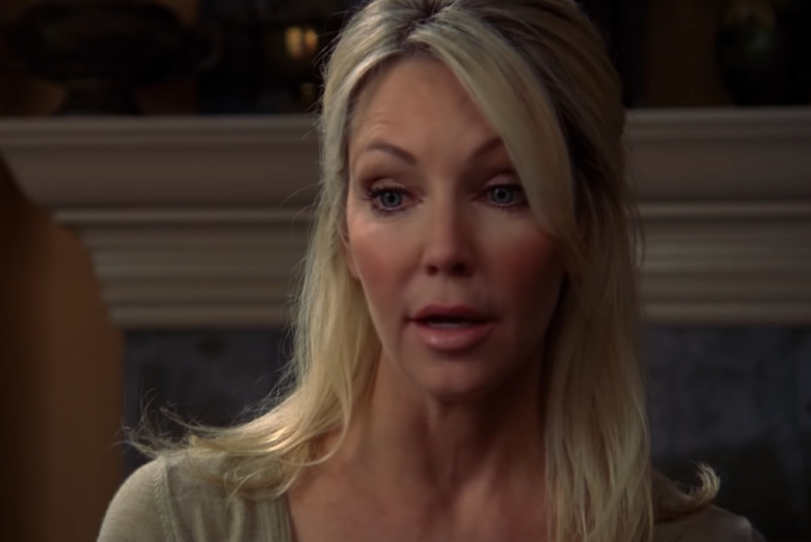 Screenshot of Heather Locklear wearing grey sweater is looking down - from Flying By (2009)