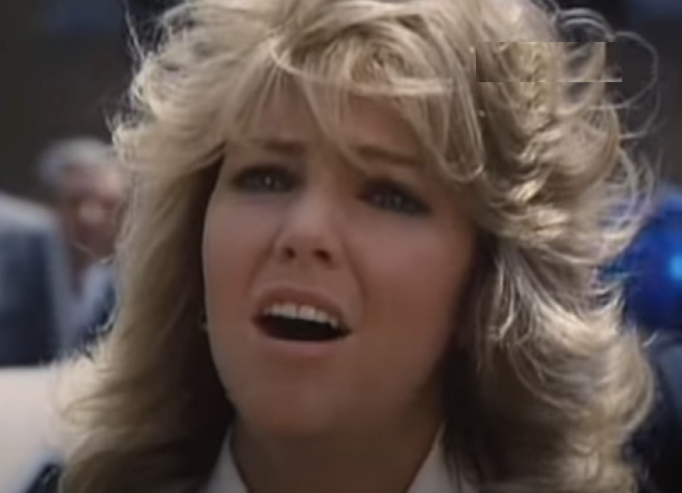 Screenshot of Heather Locklear wearing white shirt is looking up - from City Killer (1984)