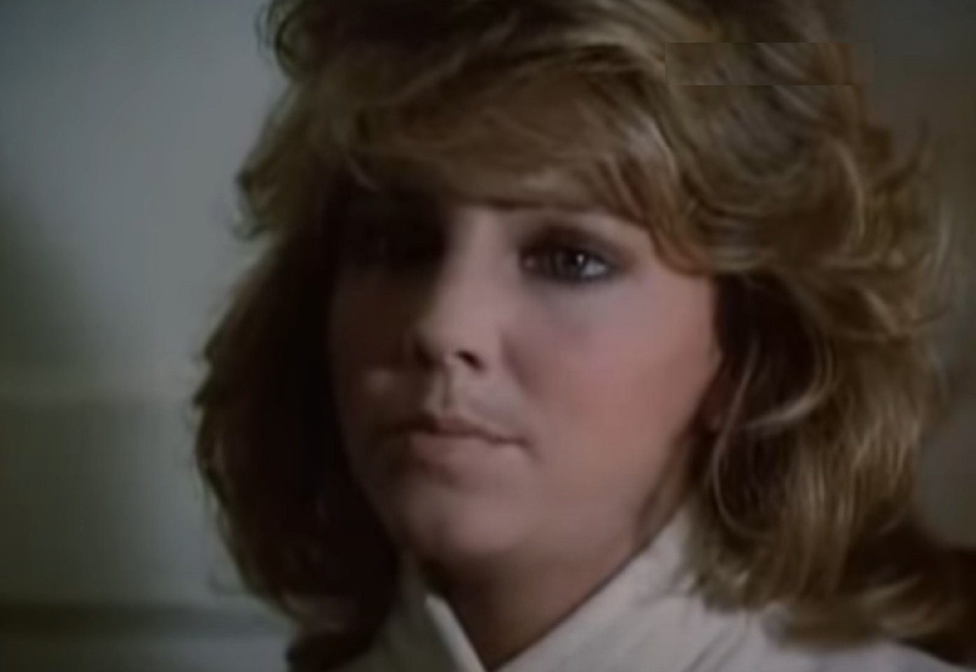 Screenshot of Heather Locklear wearing white jacket is looking at side - from City Killer (1984)