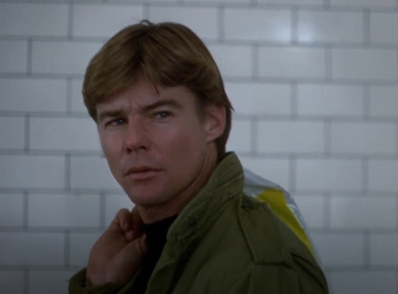 Screenshot: Jan-Michael Vincent wearing green jacket is looking upset - from Defiance (1980)