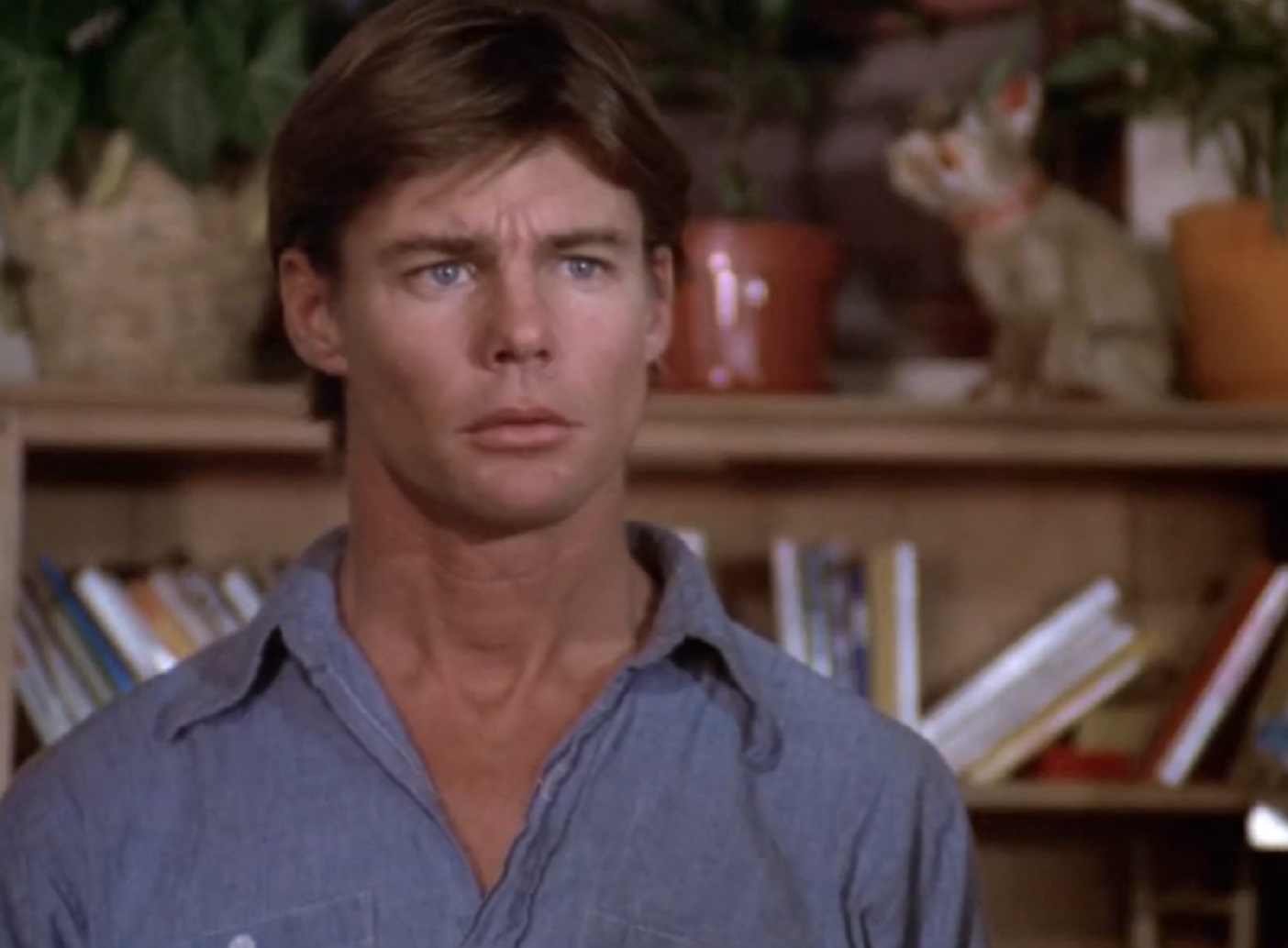 Screenshot: Jan-Michael Vincent wearing blue shirt is looking upset - from Defiance (1980)