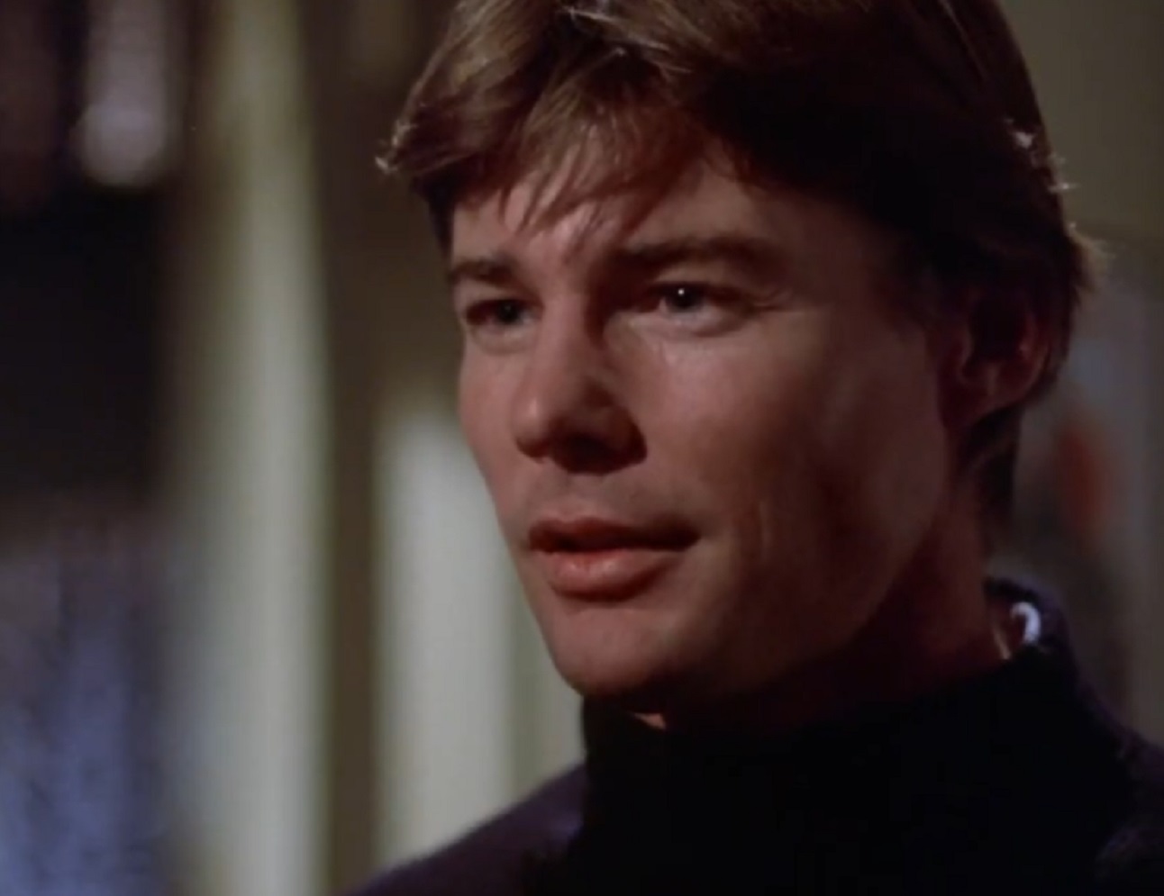 Screenshot: Jan-Michael Vincent wearing black shirt is looking at side - from Xtro Ii- The Second Encounter (1991)