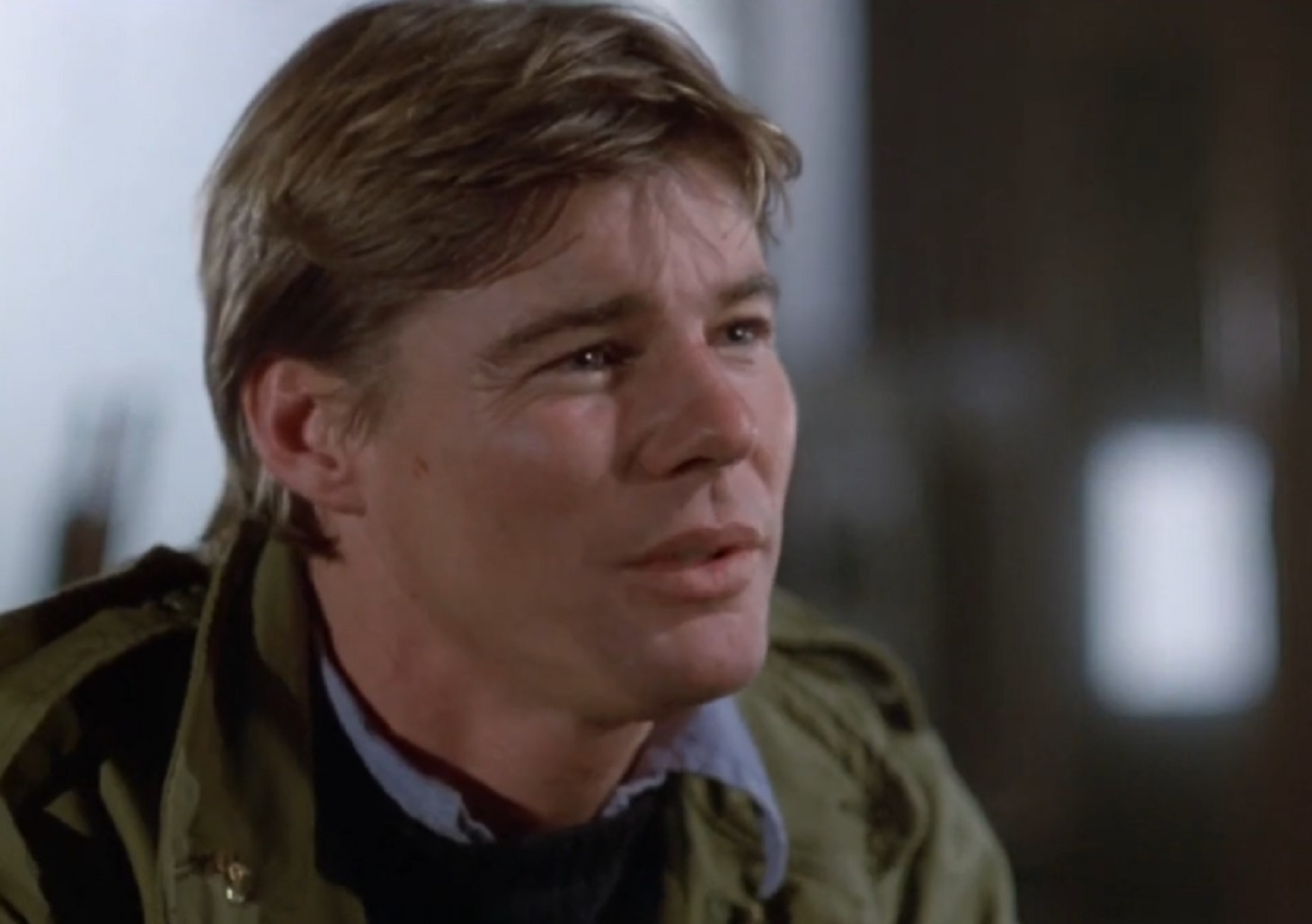 Screenshot: Jan-Michael Vincent wearing green jacket is looking at side - from Xtro Ii- The Second Encounter (1991)