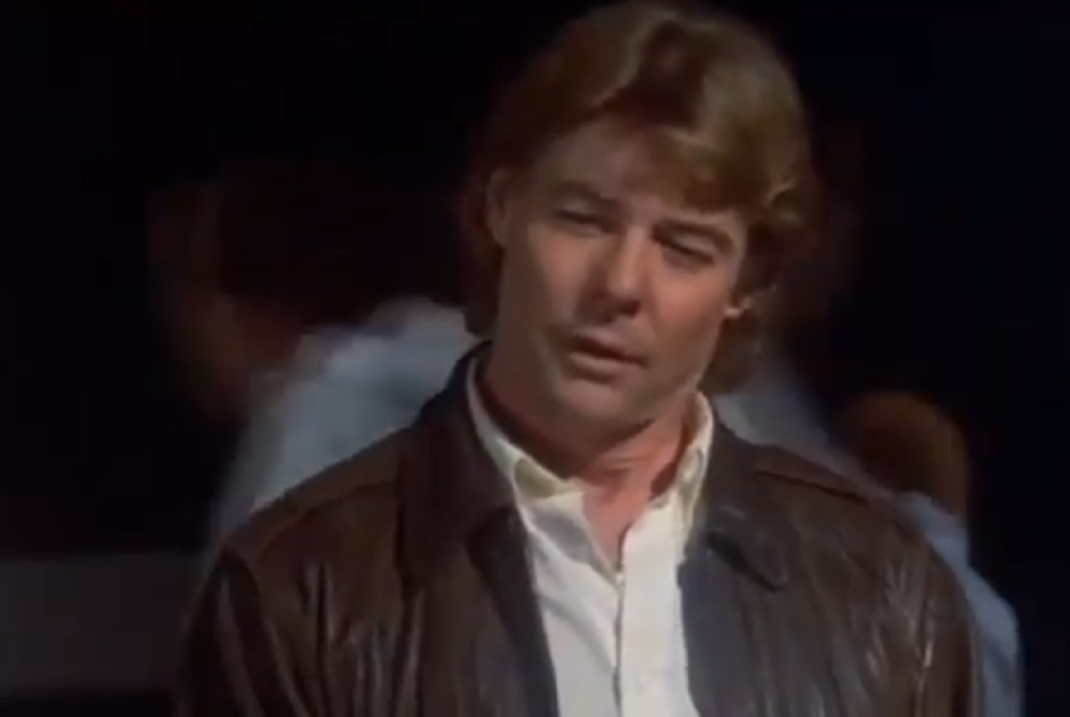 Screenshot: Jan-Michael Vincent wearing brown leather jacket is looking sad - from Xtro Ii- The Second Encounter (1991)