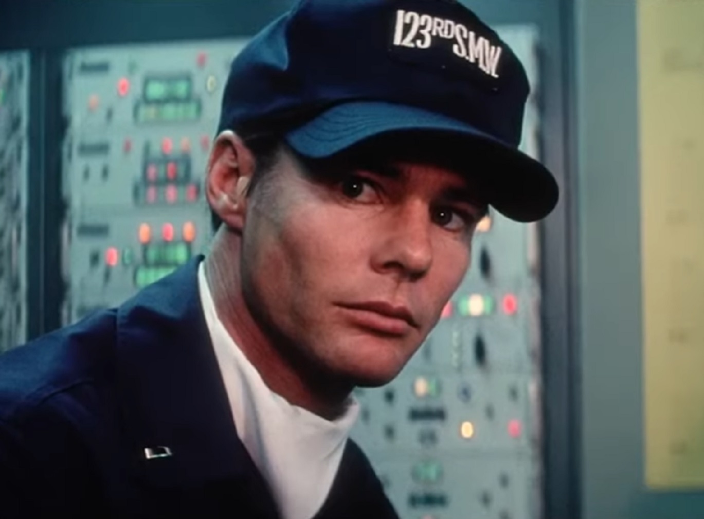 Screenshot: Jan-Michael Vincent wearing black uniform and hat is looking at camera - from Damnation Alley (1977)