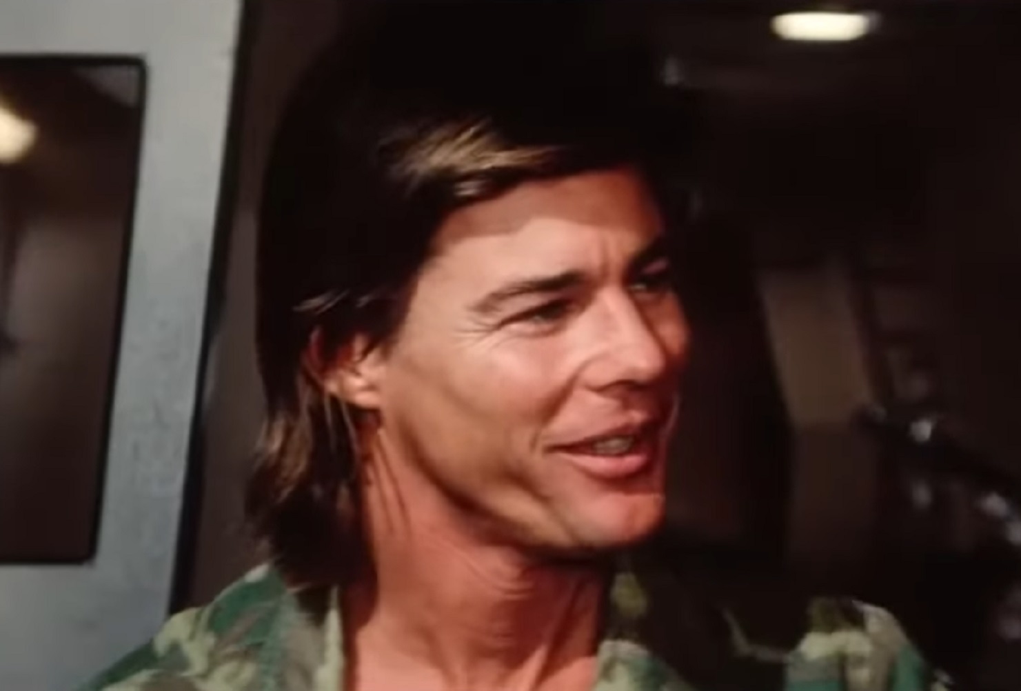 Screenshot: Jan-Michael Vincent wearing military uniform is looking at side and smiling - from Damnation Alley (1977)