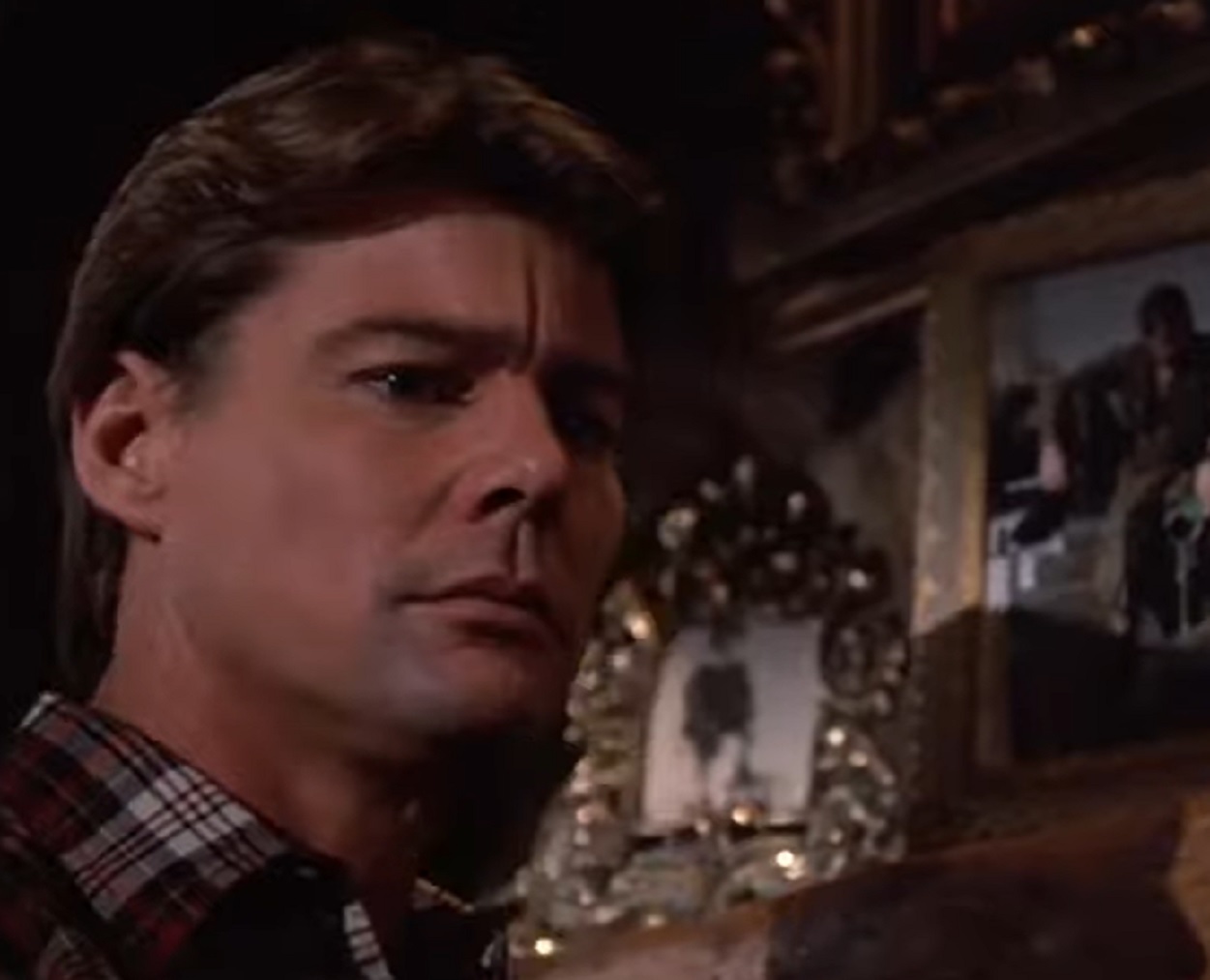 Screenshot: Jan-Michael Vincent wearing shirt is looking down sad - from Airwolf (1984-86)