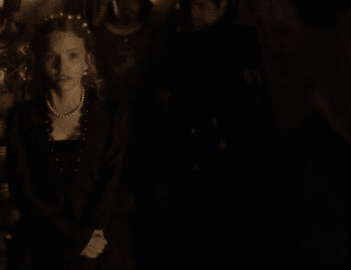 Screenshot of Catherine Howard with long hair looking at front scared- from The Tudors (2007–2010)