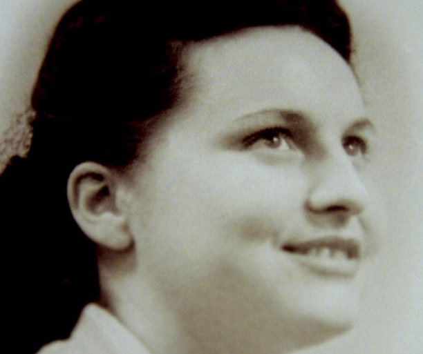 Grayscale photo of Jacqueline Fleury, French Resistant woman, smiling