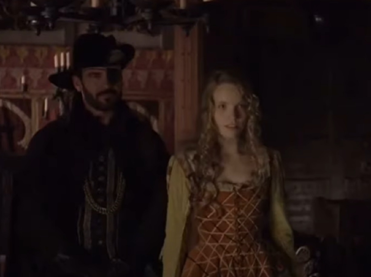 Screenshot of Catherine Howard with long hair standing next to male - from The Tudors (2007–2010)