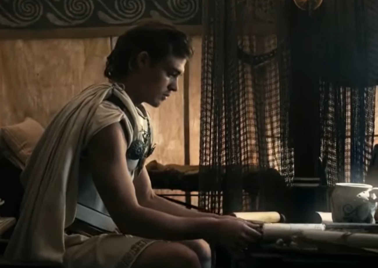 Screenshot of Alexander The Great seating at table and thinking - from Alexander the Great (2014)