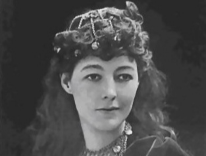 Grayscale Portrait Photo of the American musical theatre actress May Yohé, wearing black dress and a hat