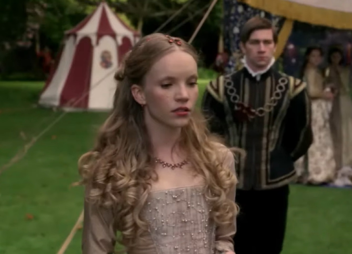 Screenshot of Catherine Howard with long hair is looking upset outside - from The Tudors (2007–2010)