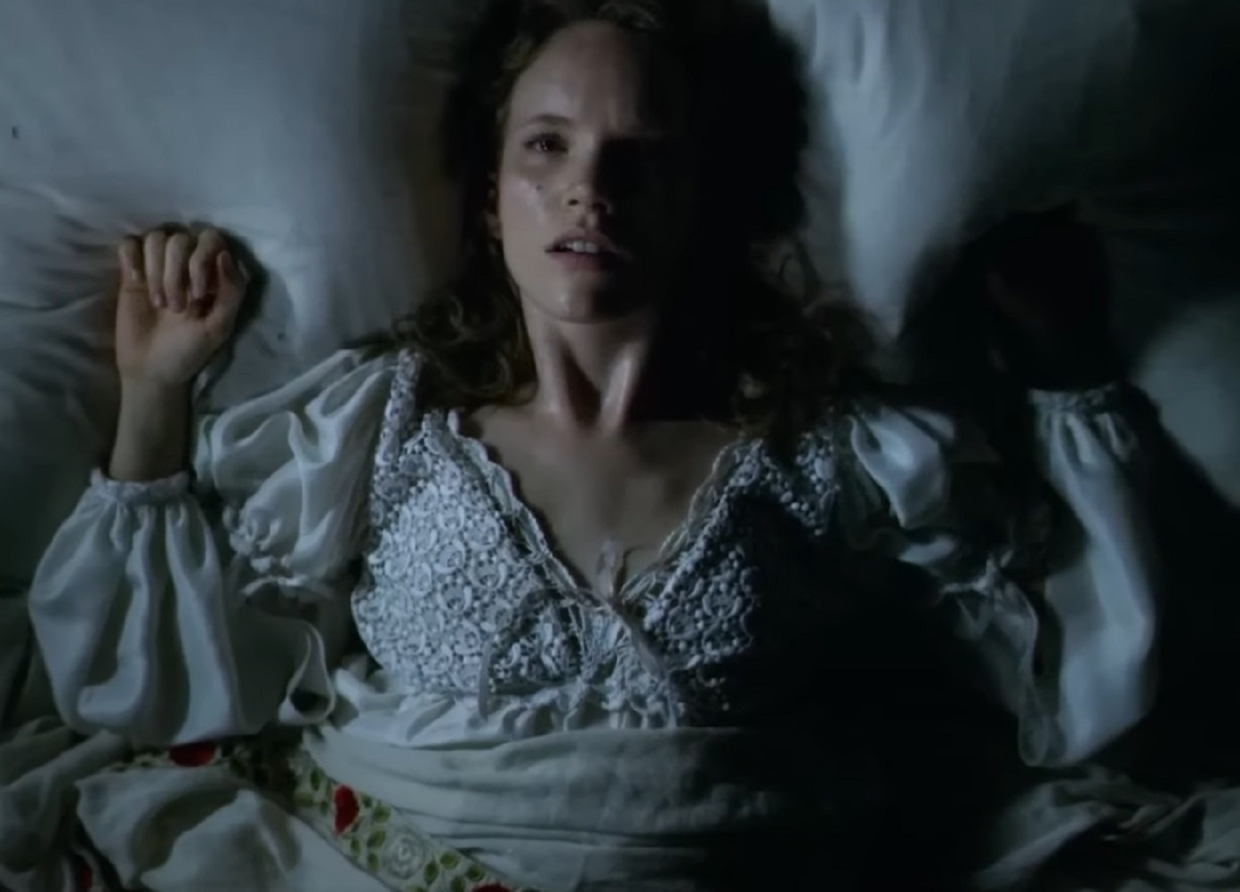 Screenshot of Catherine Howard laying on the bed with sad face - from The Tudors (2007–2010)