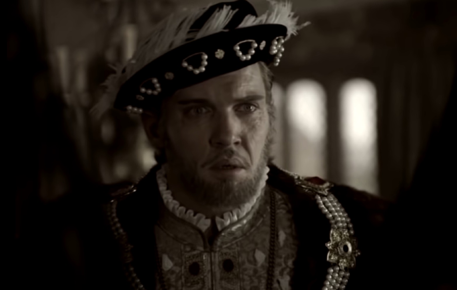 Screenshot of Henry VIII wearing black coat and hat is looking upset - from The Tudors (2007–2010)