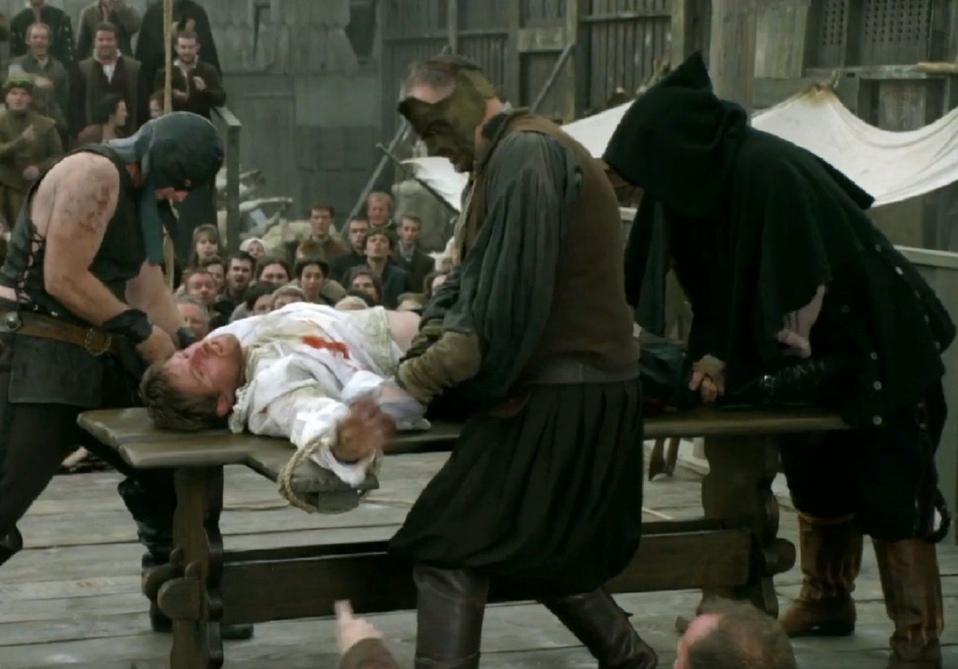 Screenshot of Francis Dereham in white shirt laying outside in pain - from The Tudors (2007–2010)