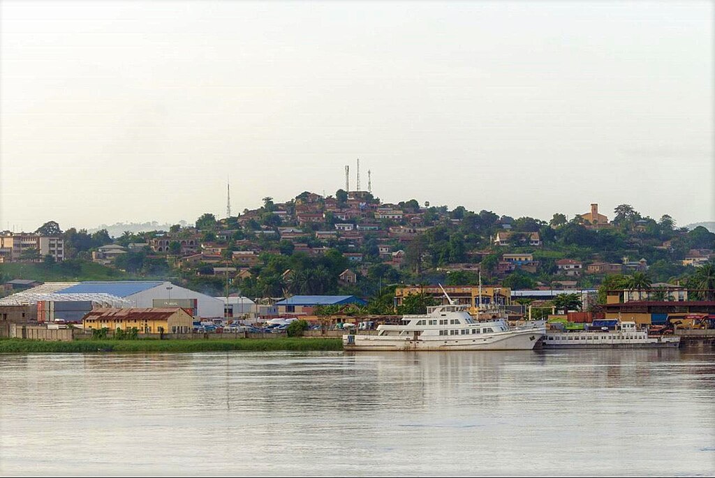 Photography of Boma a port town on the Congo River, river and ships in front, blue sky background