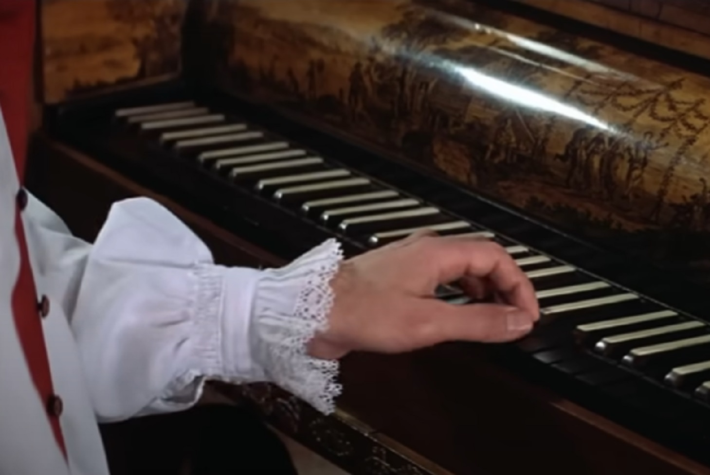 Screenshot: Wolfgang Amadeus Mozart in white shirt is playing piano - from Amadeus (1984)