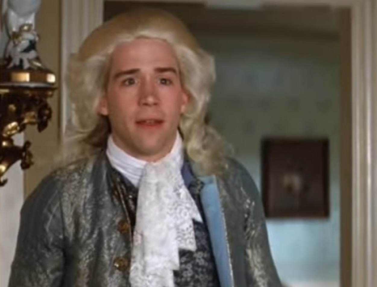 Screenshot: Wolfgang Amadeus Mozart in blue jacket is entering in room - from Amadeus (1984)