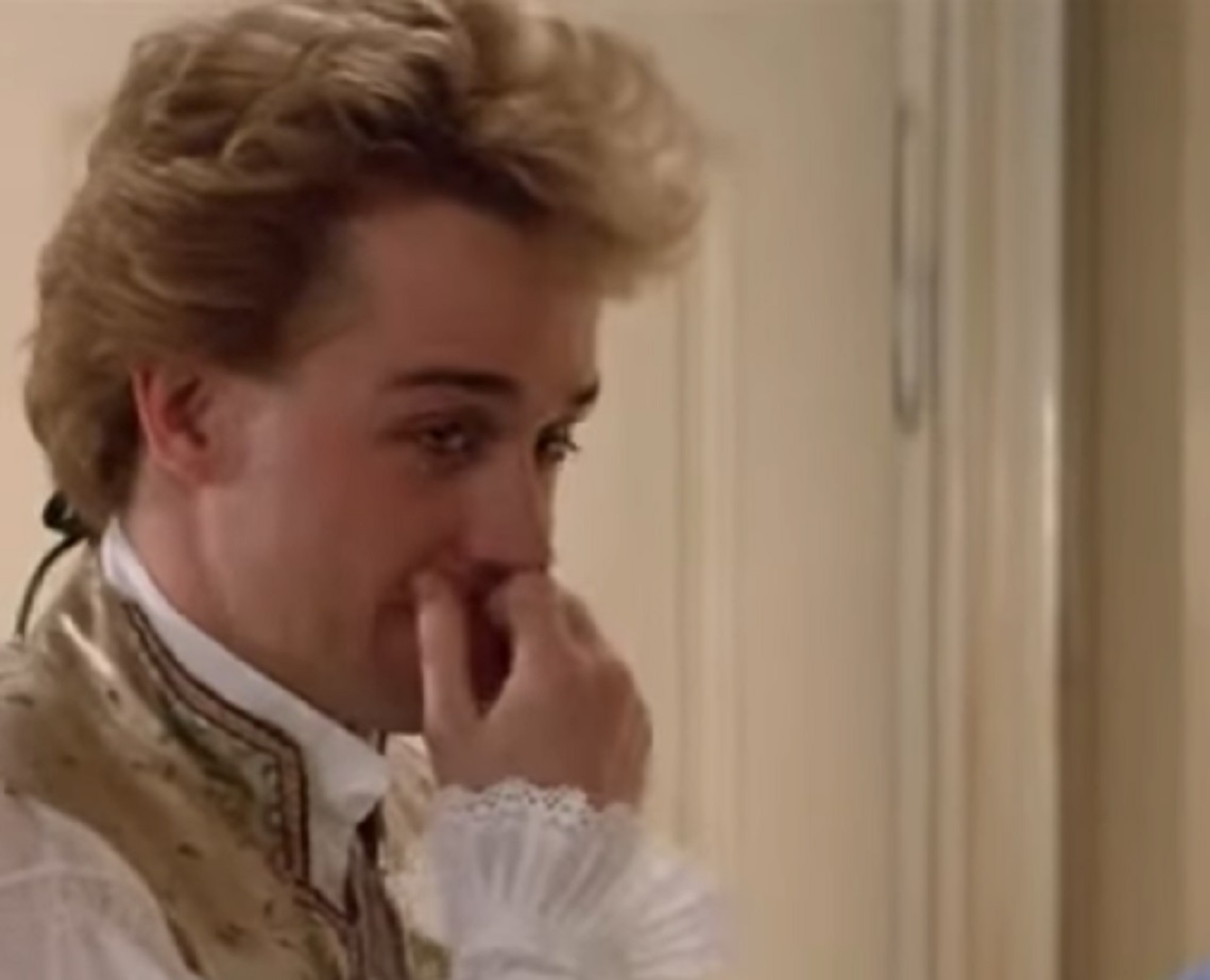 Screenshot: Wolfgang Amadeus Mozart in white shirt is thinking - from Amadeus (1984)