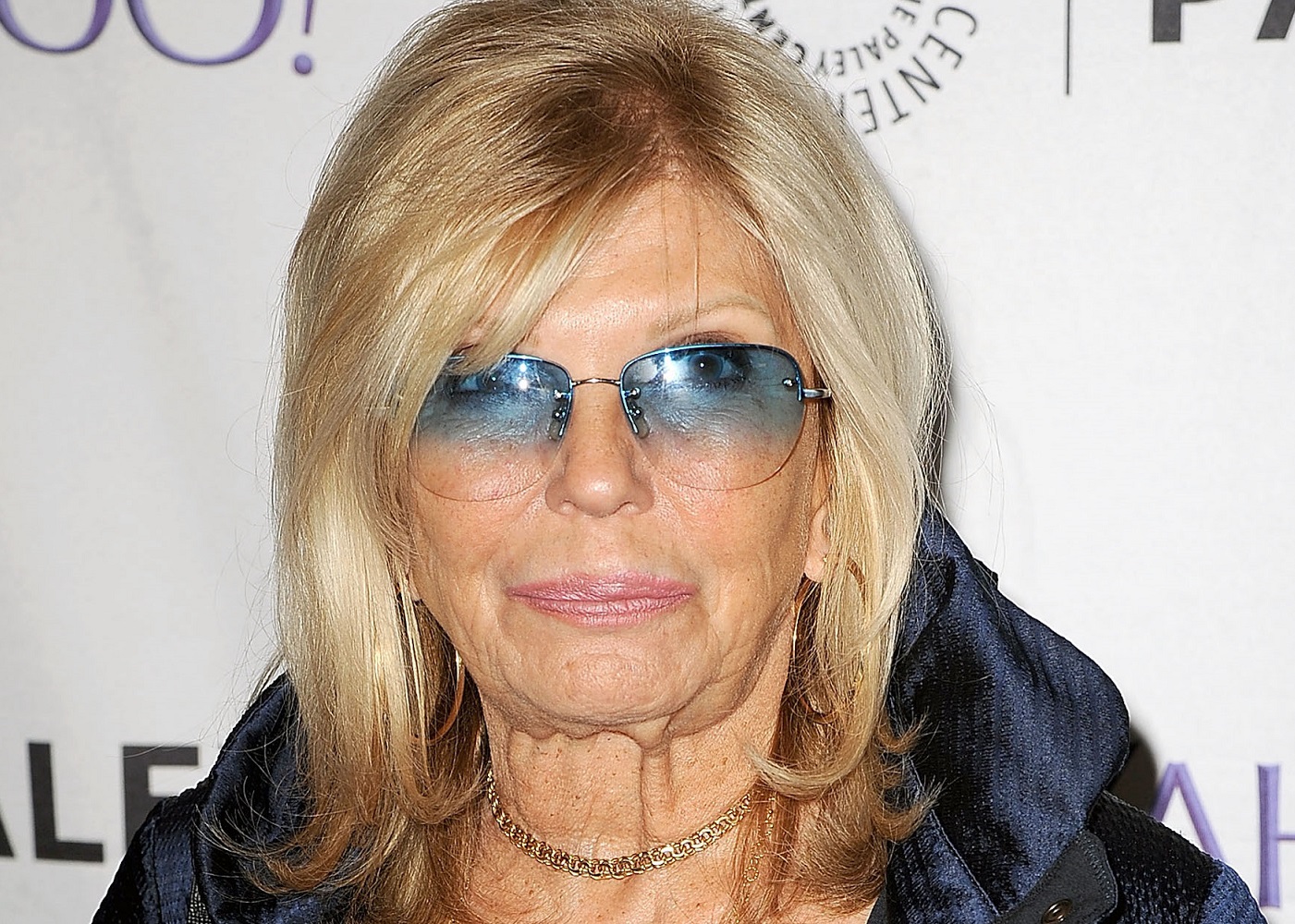 Nancy Sinatra wearing blue glasses is looking at camera - 2015