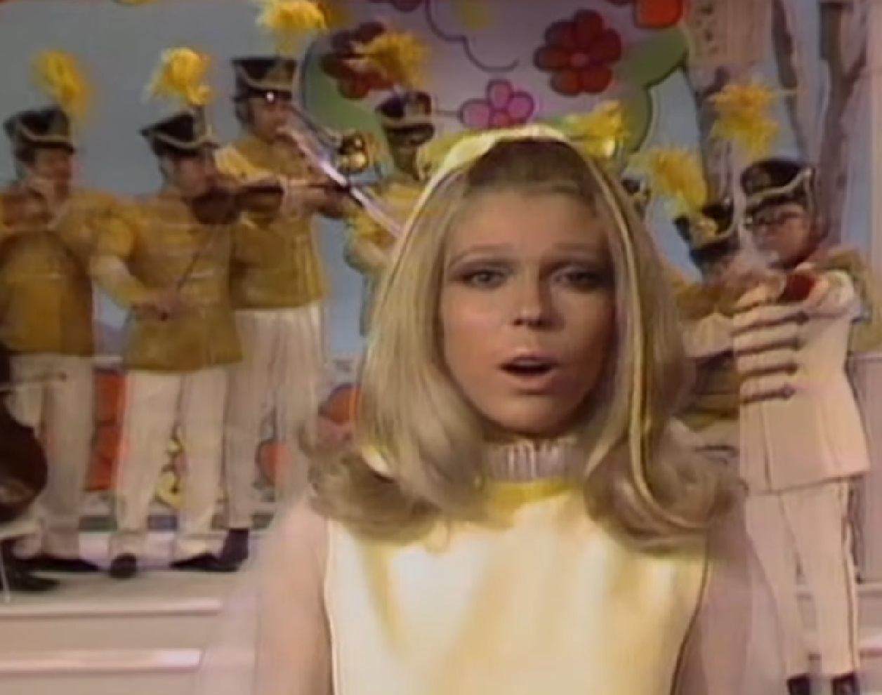 Screenshot of Nancy Sinatra wearing wearing yellow top, singing on the stage - from The Ed Sullivan Show (1948-71)