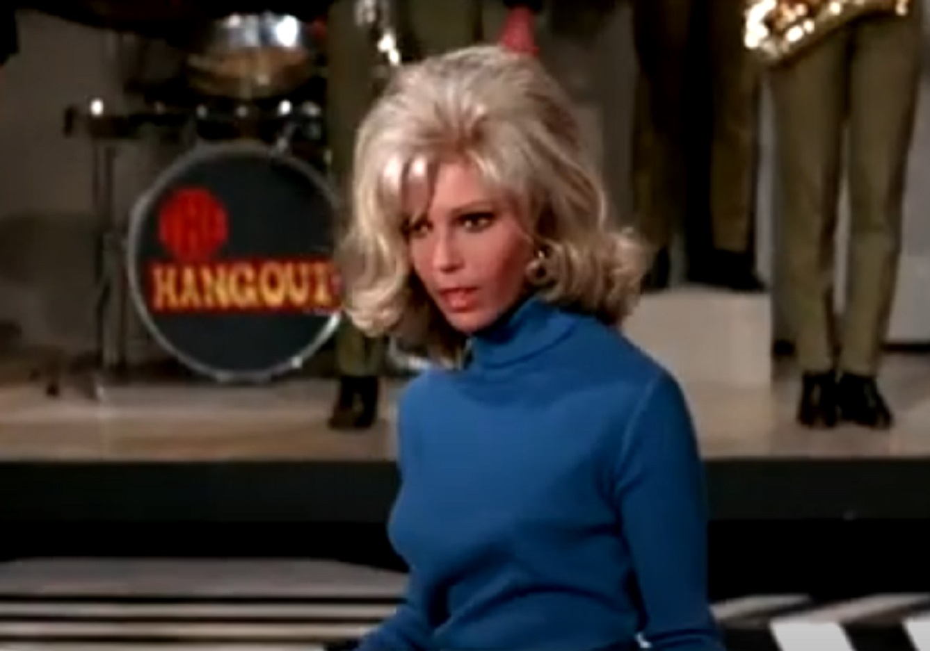 Screenshot of Nancy Sinatra wearing blue top, looking surprised - from Speedway (1968)
