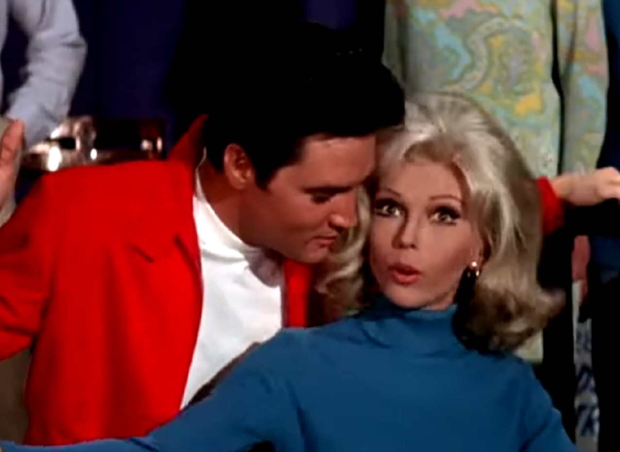 Screenshot of Nancy Sinatra looking surprised next to Elvis Presley - from Speedway (1968)