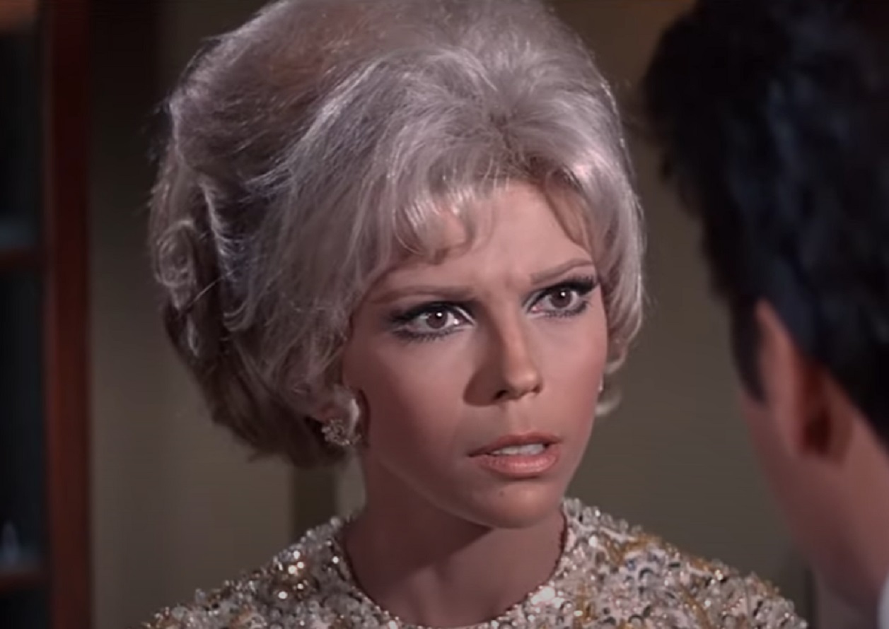 Screenshot of Nancy Sinatra in white dress ,looking shocked - from Speedway (1968)
