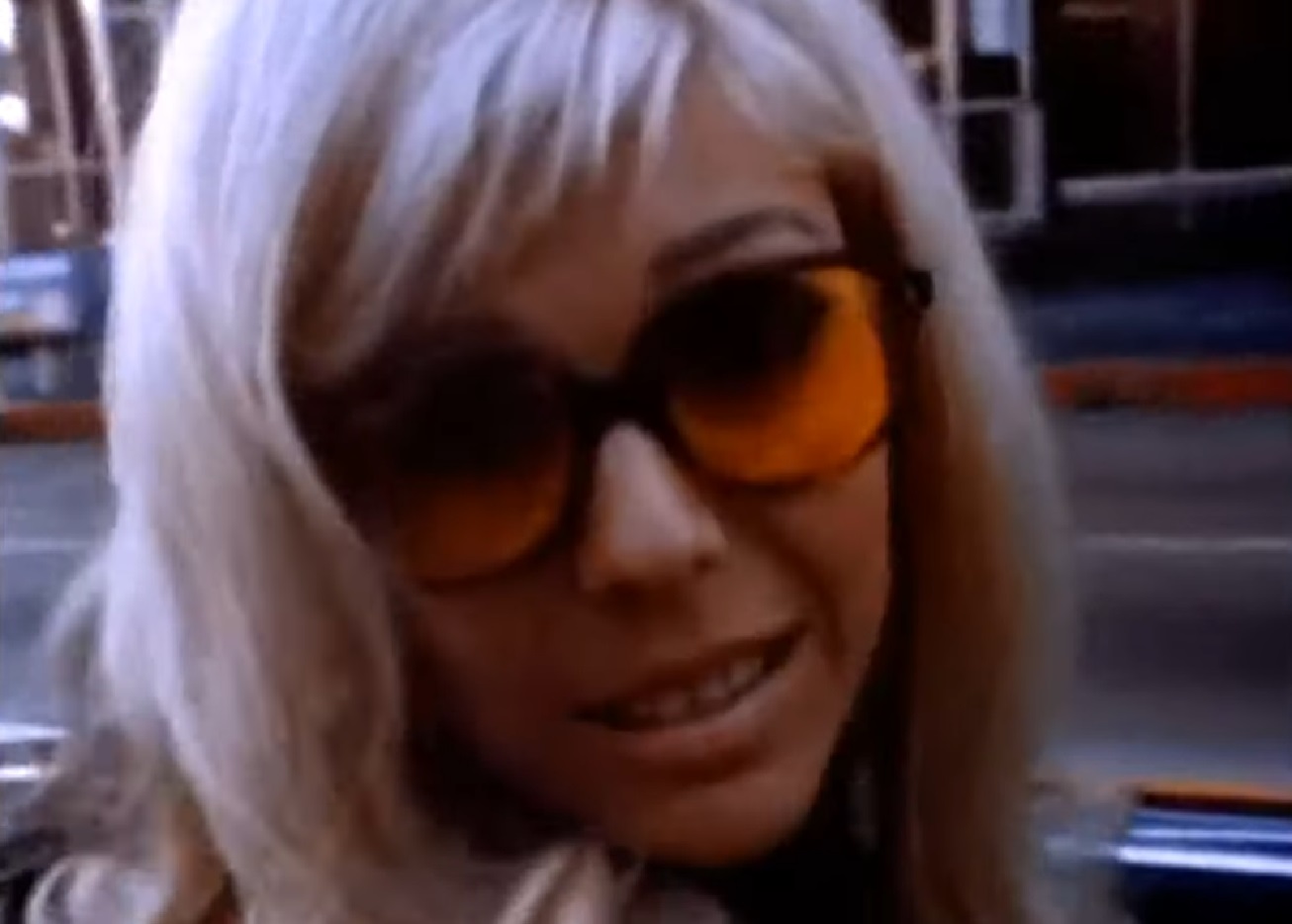 Screenshot of Nancy Sinatra wearing orange glasses is looking at camera - from Movin  With Nancy (1967)