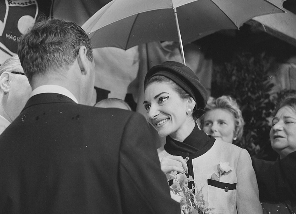 Grayscale Portrait Photo of Maria Callas wearing a white outfit and dark hat